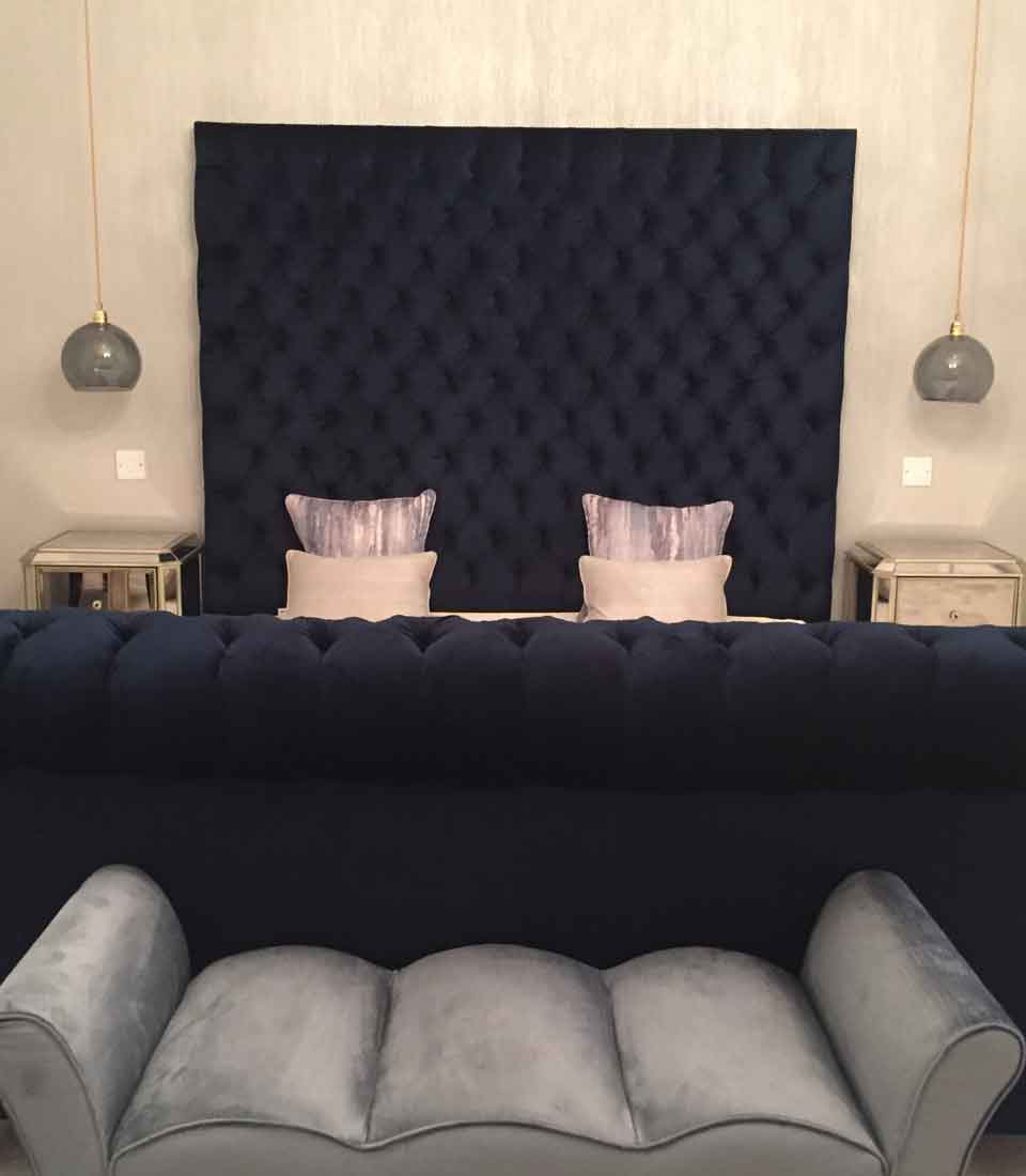 Bespoke navy velvet master bed with buttoned headboard