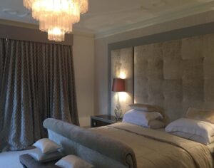 bespoke soft grey velvet master bed with headboard