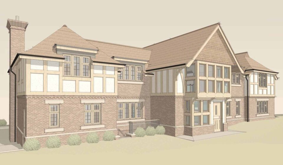 A large residential building features varied architectural styles, including brick and wood elements. It has multiple steep roofs and several windows, situated in a grassy area with shrubs.