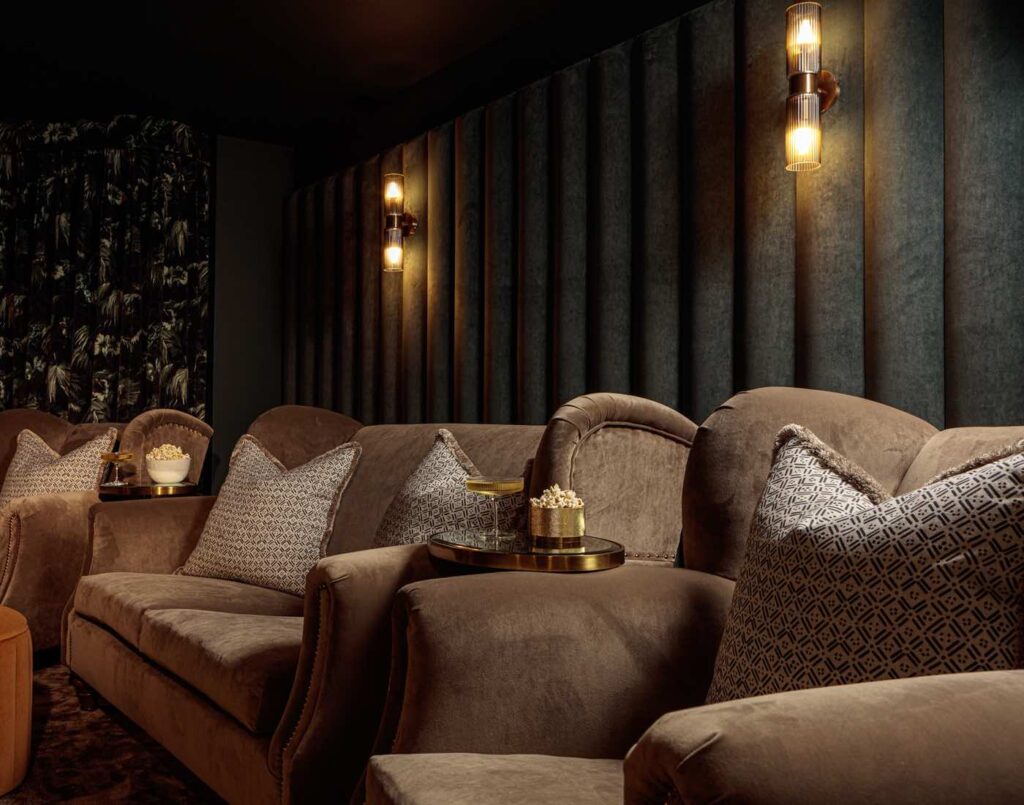 Dark tones velvet cinema room with luxurious armchairs and cocktail table