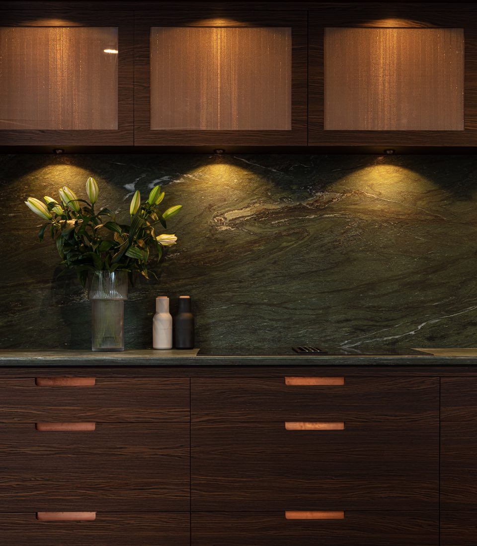 Dark wood kitchen with green marble splashback