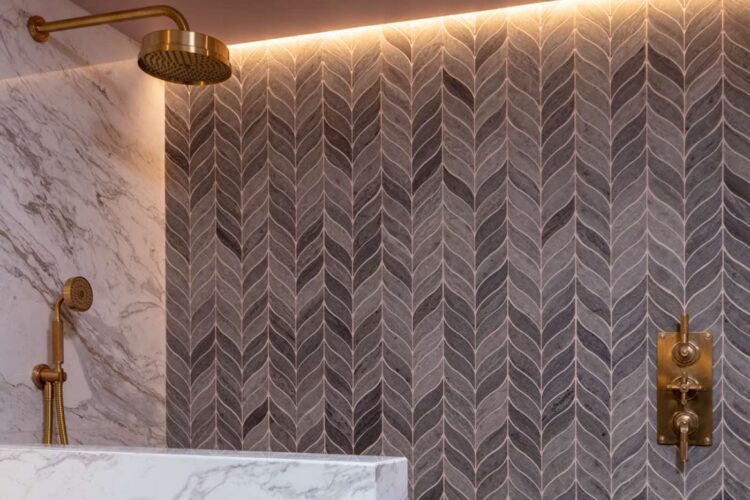 Bathroom with brass fittings, marble walls and decorative tiling