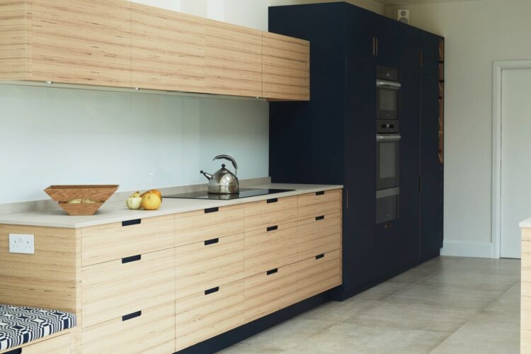 Scandi inspired kitchen with wood and navy cupboards