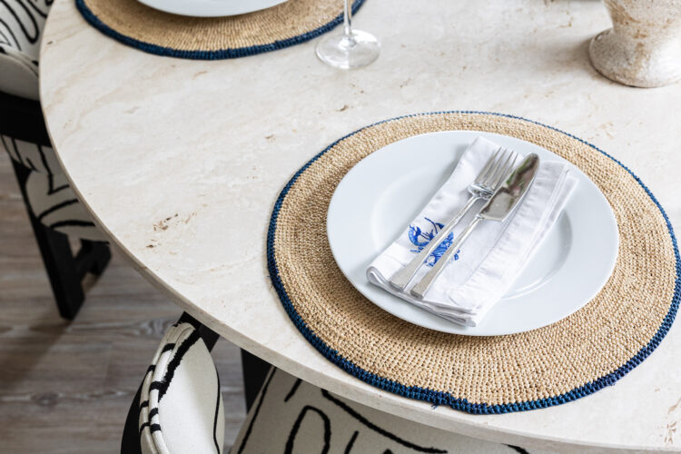 urban contemporary neutral apartment dining table setting geometric black and white chairs with travertine stone octagonal table