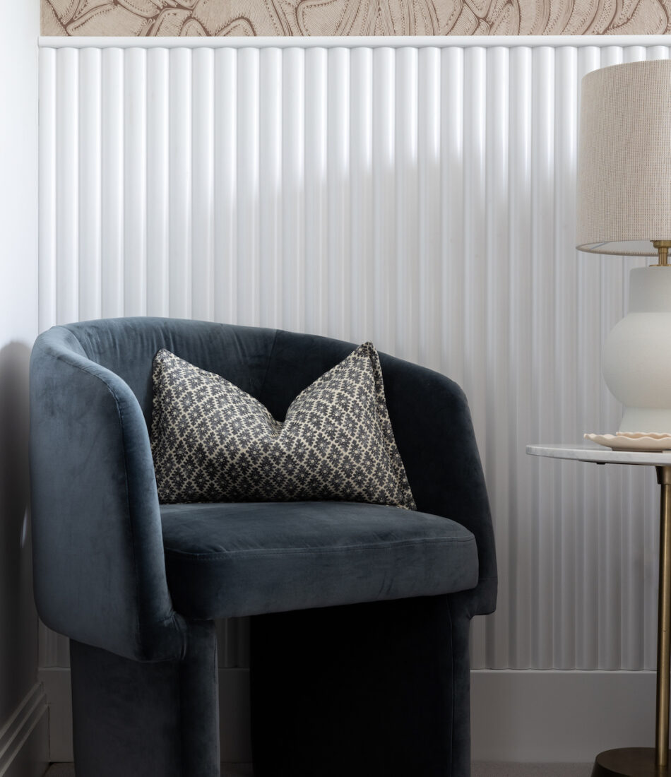 urban contemporary contemporary dusty blue velvet chair in bedroom in front of bespoke joinery wall and roped textural wallpaper