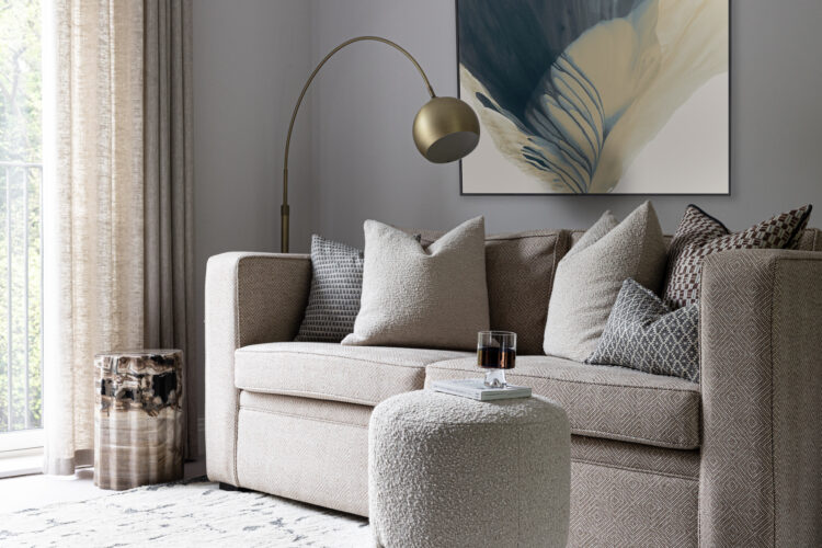 urban contemporary bespoke upholstered sofa bed with bespoke soft furnishings, footstools and petrified wood plinth