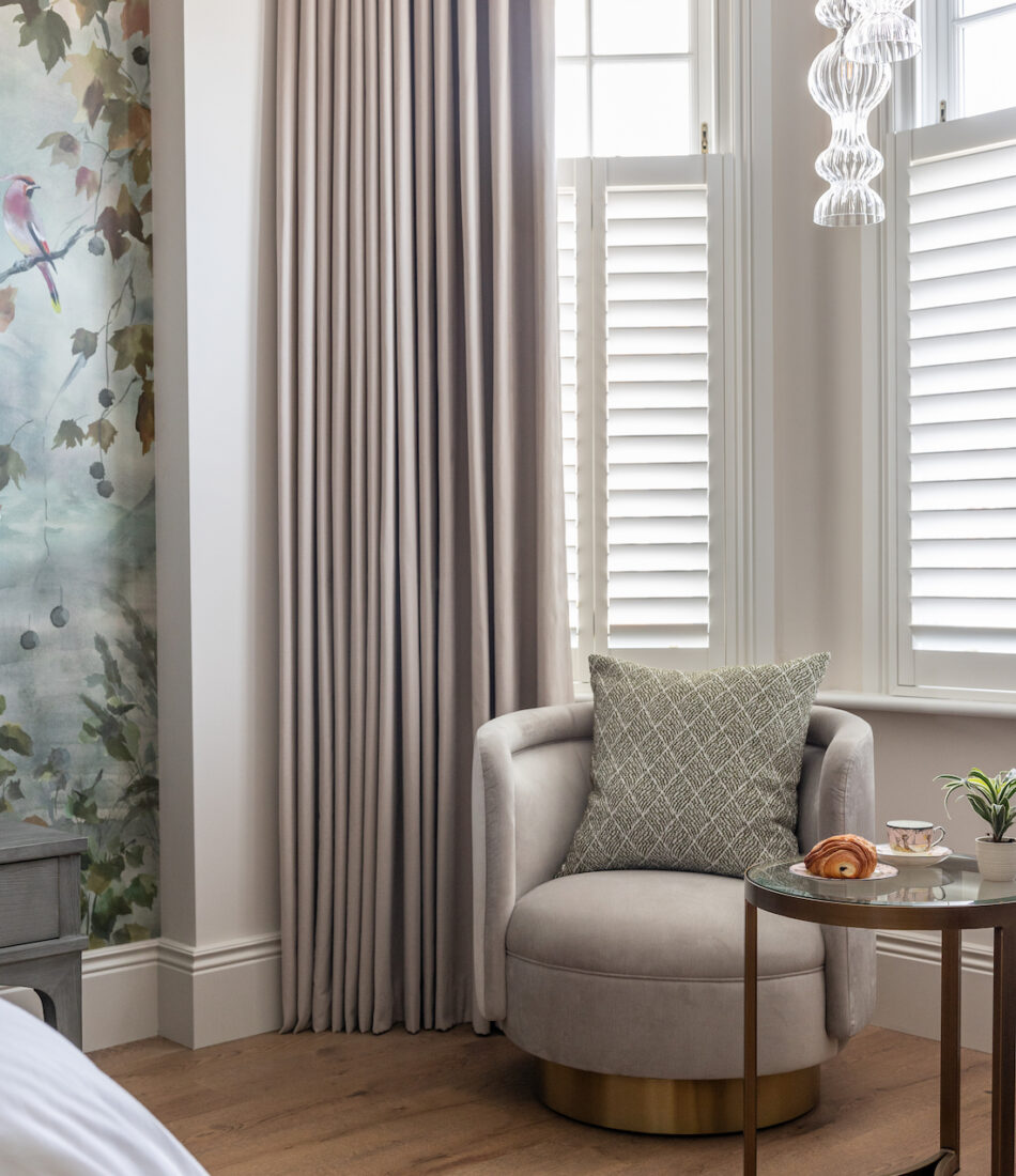 Contemporary Bedroom Designed with Bespoke headboard and Mural Wallpaper by Pfeiffer Design. bespoke upholstered chair, bespoke window treatments and custom lighting design. Neutral colour palette with warm lighting design