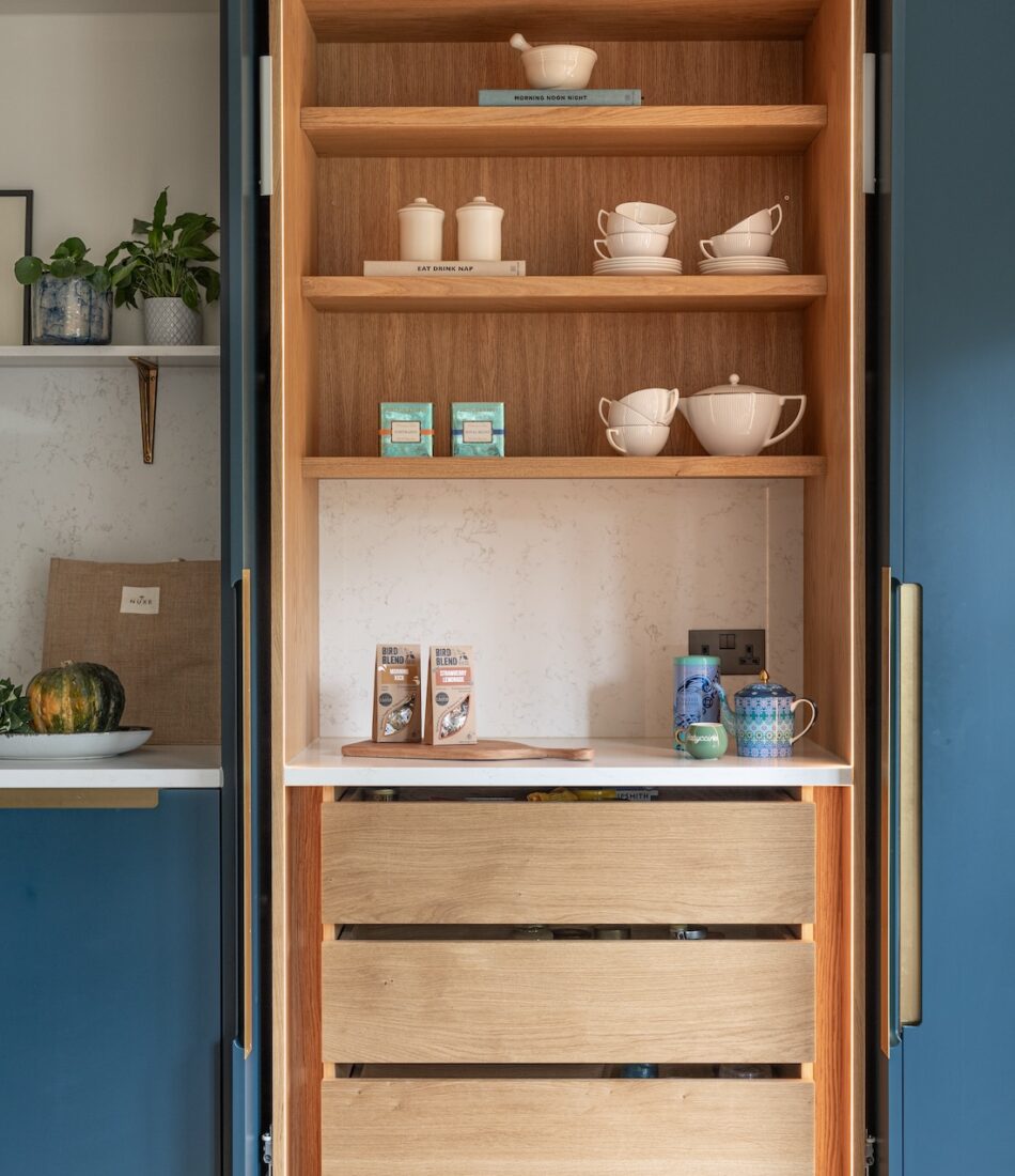 Art Deco Inspired Bespoke Kitchen made by our bespoke joiners, designed by Pfeiffer Design. Breakfast cabinet with pocket system sliding doors, handy drawers and shelving for easy mornings, brass insert handles, light timber chevron flooring