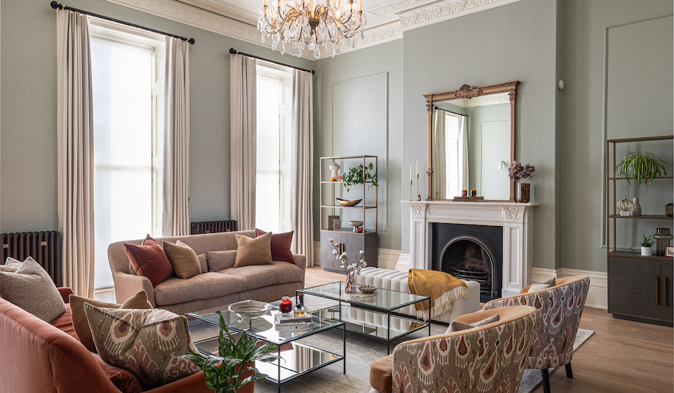 Regency Townhouse Lounge Living Room Interior Design with pops of red, yellow, blue, green warm tones and tall ceilings