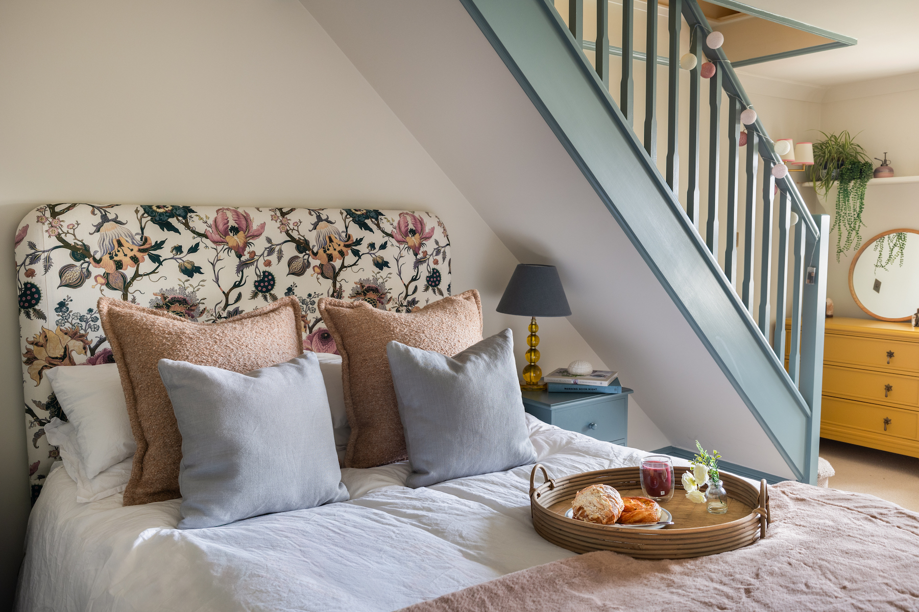 Girls bedroom design with floral headboard, pops of blue and yellow