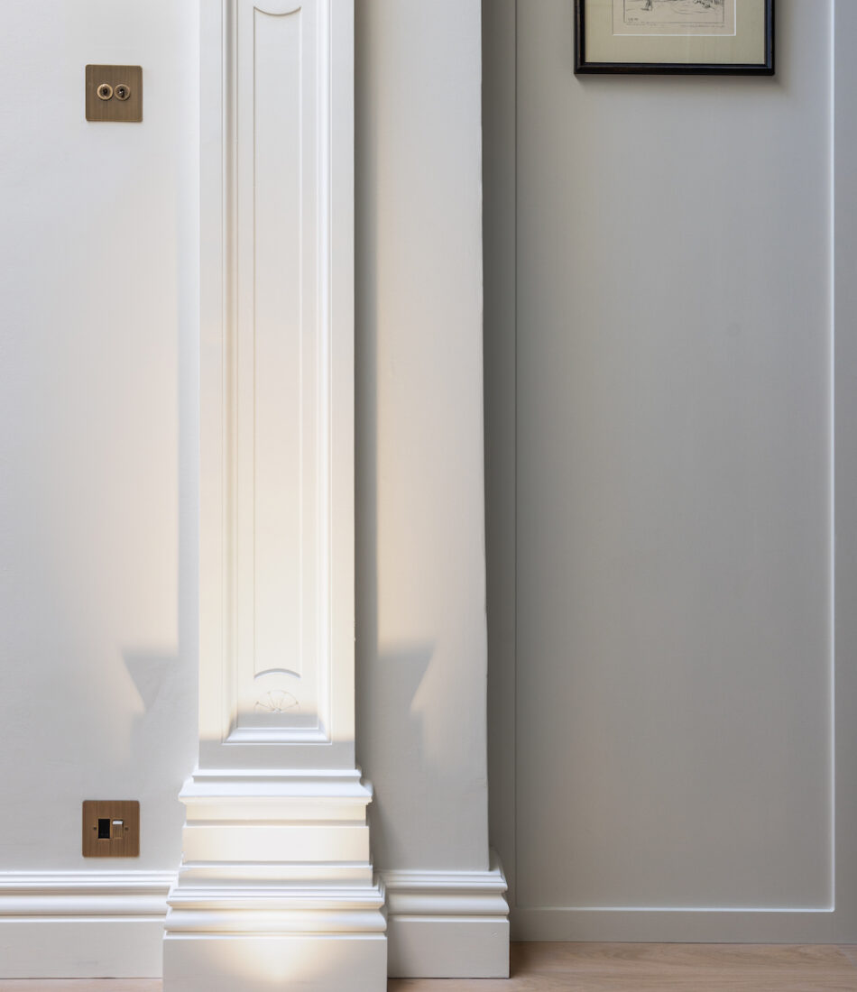 Architectural features within home being lit by floor spot lights - lighting design package