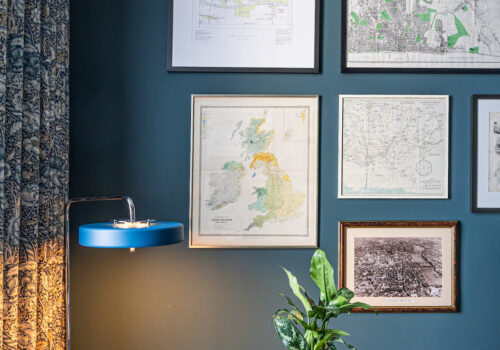 Study, Desk, Library space with navy walls and blue, orange pops of colour, patterned curtains and framed collage of maps