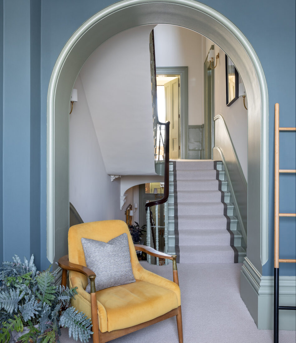 View of landing through archway, contrast paint on walls to skirting, green, blues, yellows