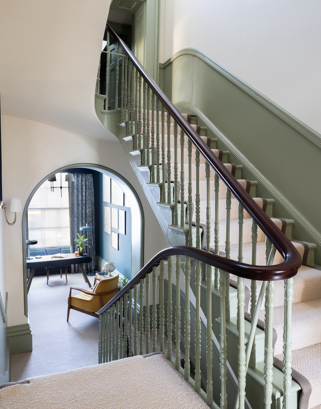 Firs floor hallway showing stairs and balustrade design, Spindles and half height panelling painted in green with dark oak hand rail