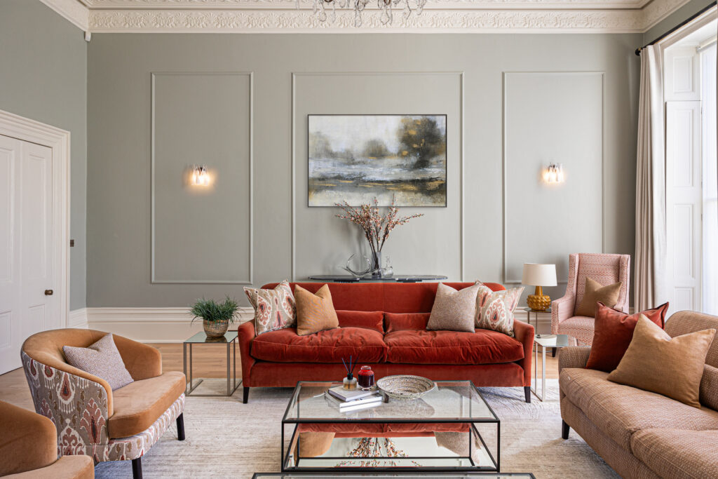 Regency Townhouse Lounge Living Room Interior Design with red, beige, warm patterns and yellow cushions