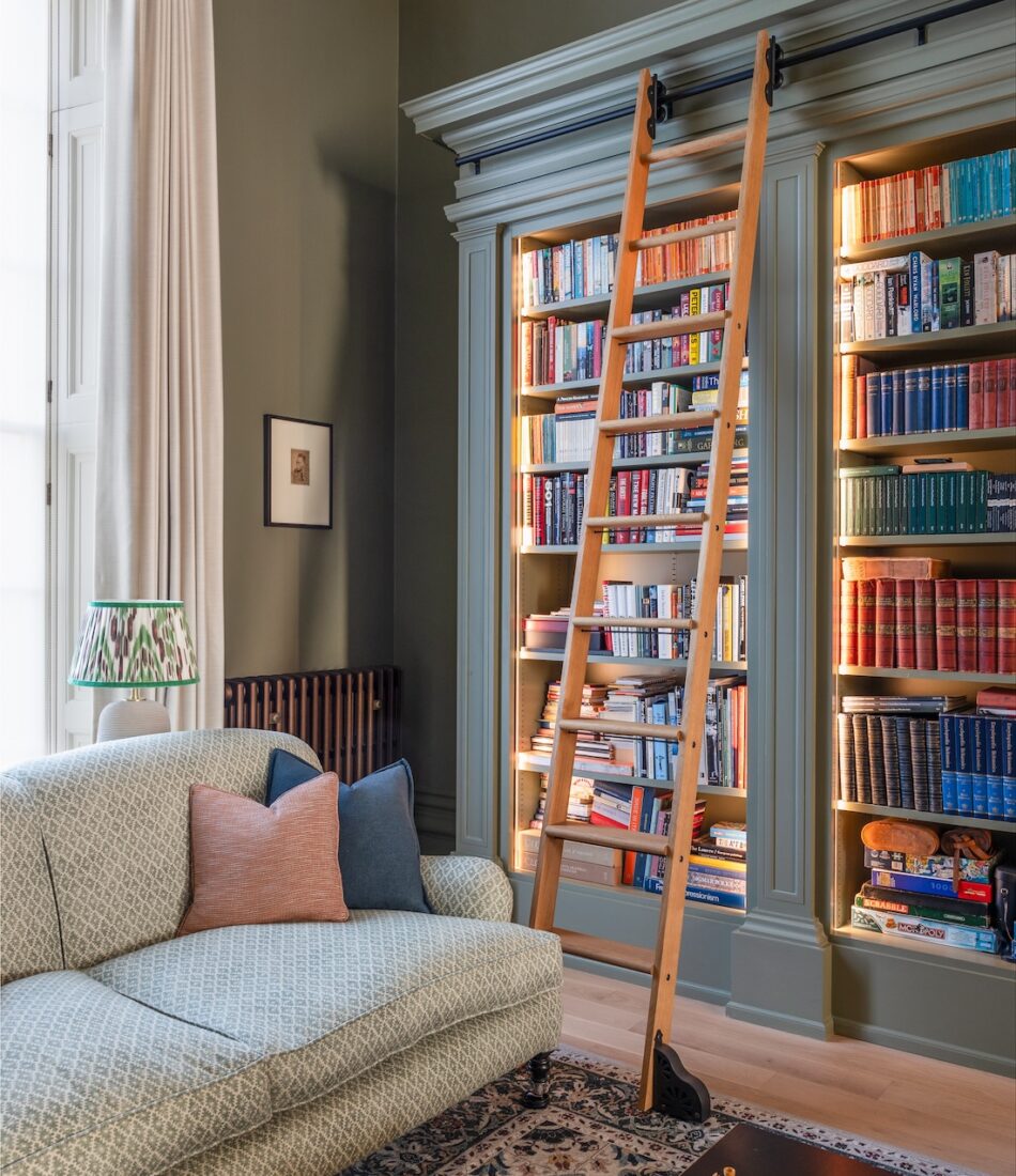 Regency Townhouse Lounge Living Room Interior Design with pops of red, yellow, blue, green warm tones and tall ceilings