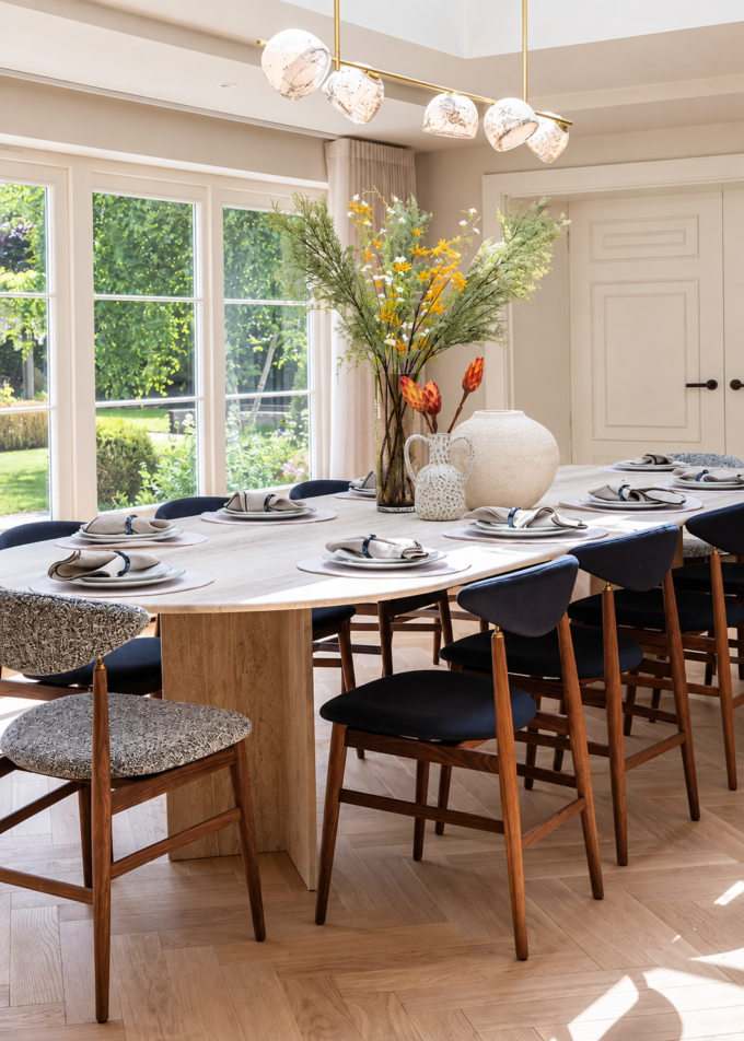 Contemporary dining room with elegant lighting and floral centrepiece.