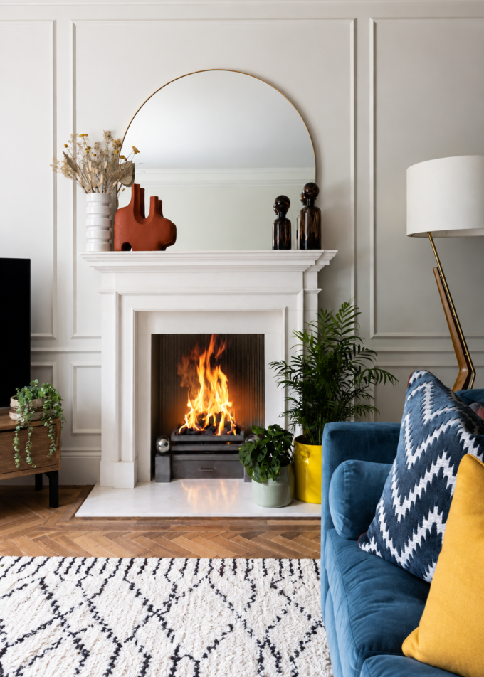 Elegant living room with a feature fireplace and blue sofa.