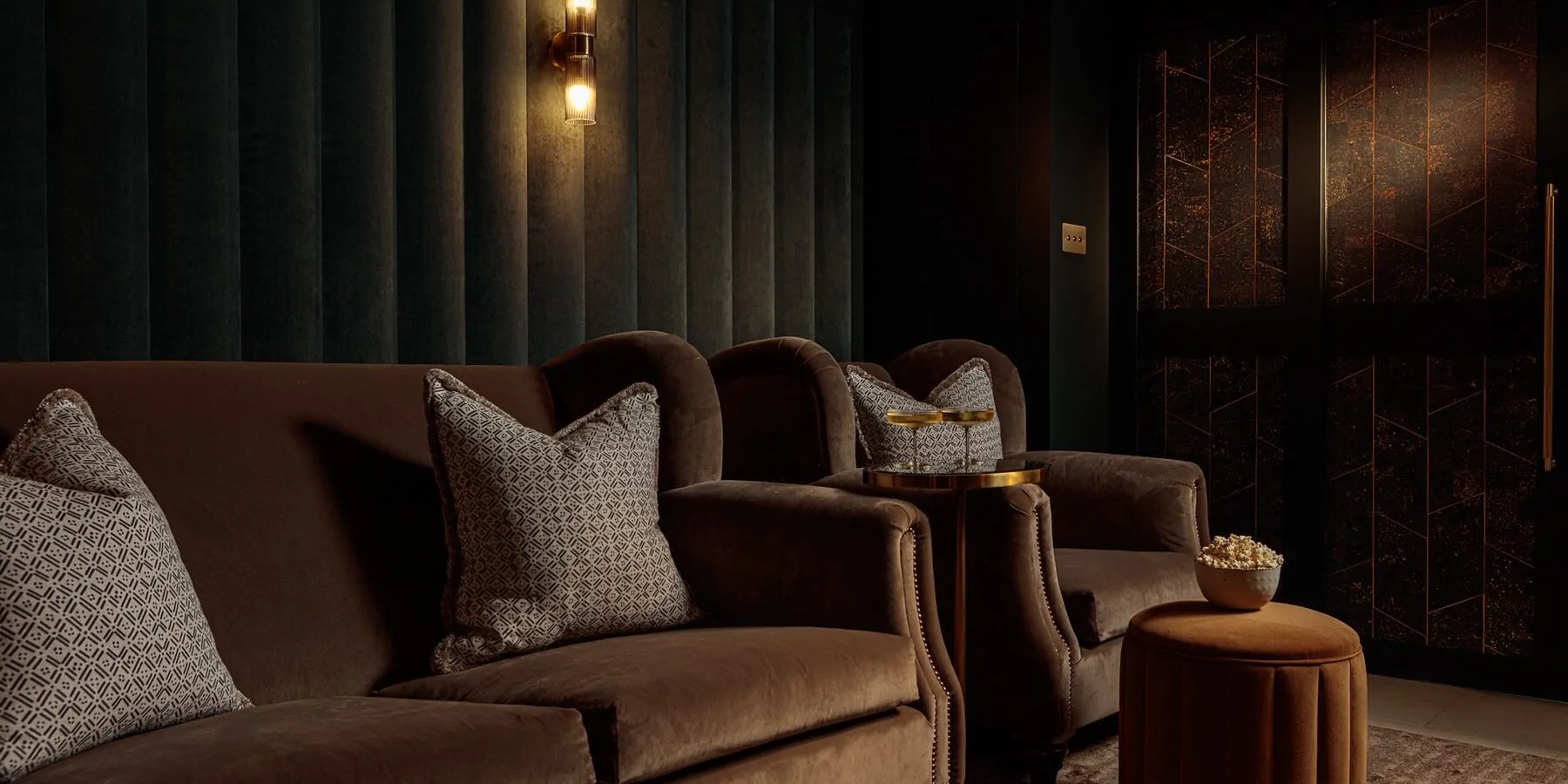 Dark tones velvet cinema room with luxurious armchairs and cocktail table