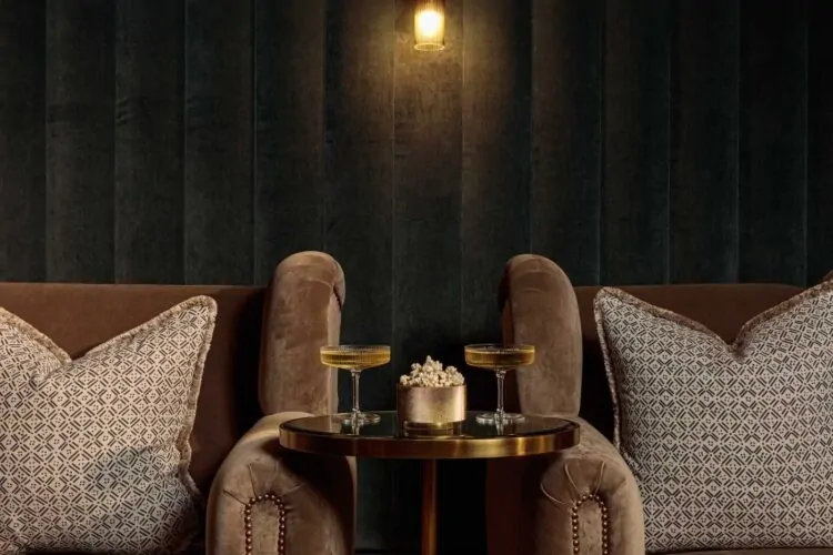 Dark tones velvet cinema room with luxurious armchairs and cocktail table
