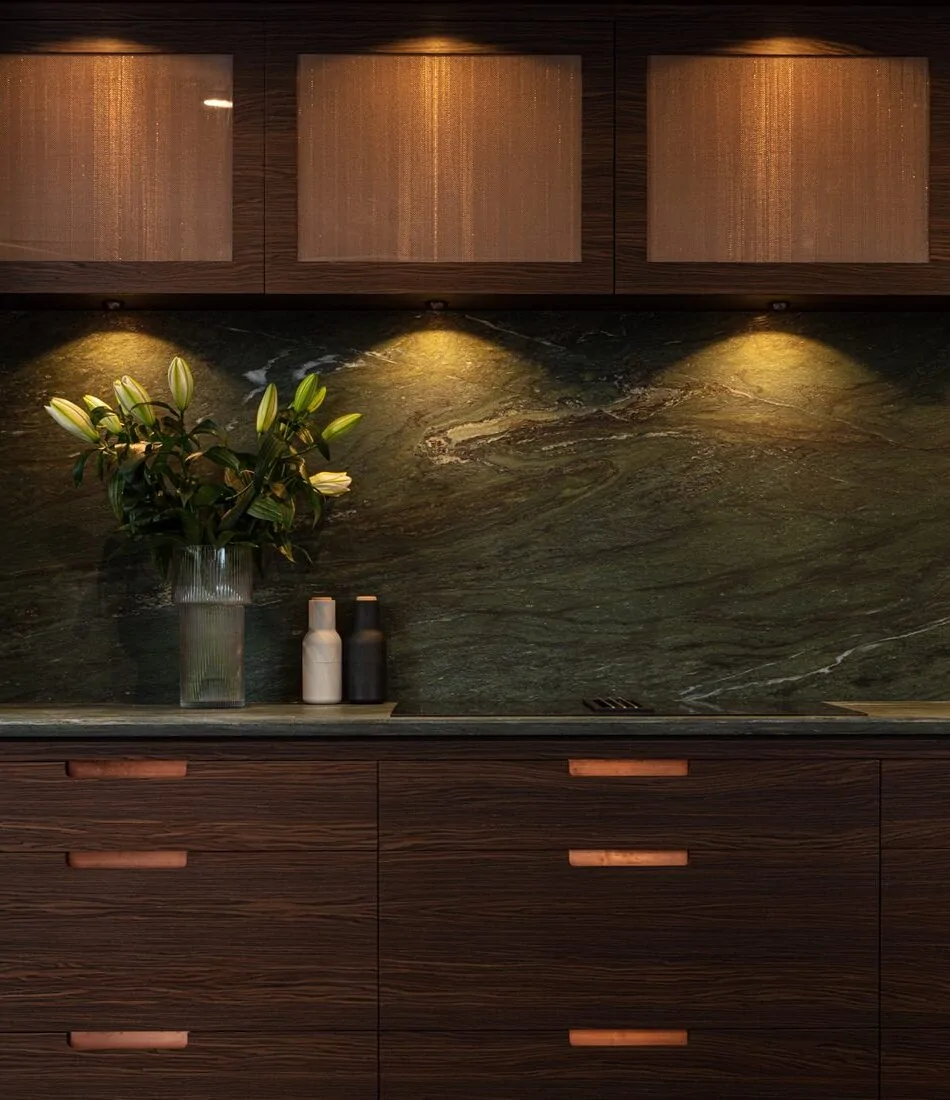 Dark wood kitchen with green marble splashback