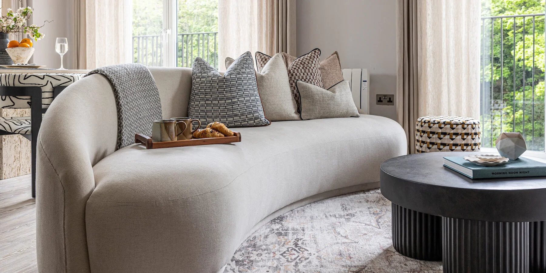 urban contemporary bespoke curved sofa upholstered by our trusted upholsterers in neutral tones and natural materials