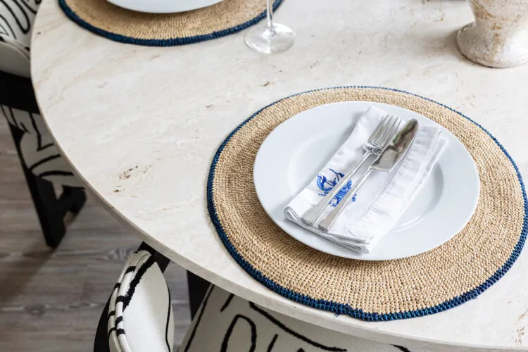 urban contemporary neutral apartment dining table setting geometric black and white chairs with travertine stone octagonal table