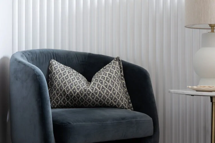 urban contemporary contemporary dusty blue velvet chair in bedroom in front of bespoke joinery wall and roped textural wallpaper