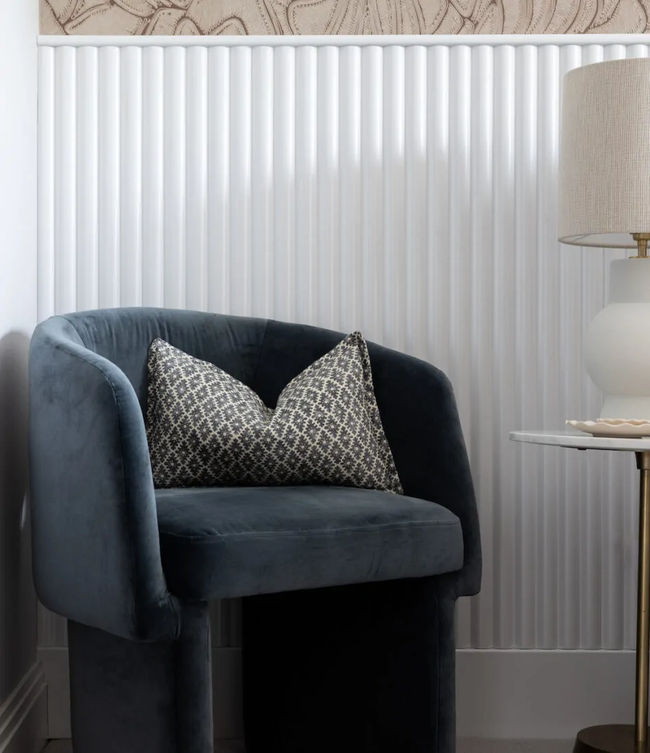 urban contemporary contemporary dusty blue velvet chair in bedroom in front of bespoke joinery wall and roped textural wallpaper