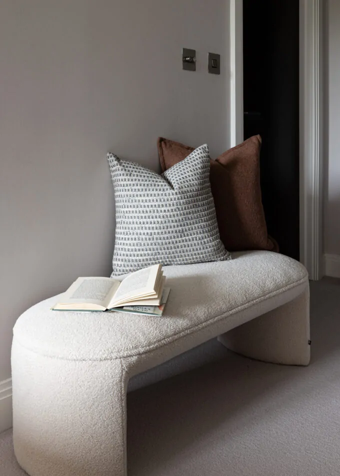 urban contemporary boucle bench in bedroom with bespoke soft furnishing and cushion scheme