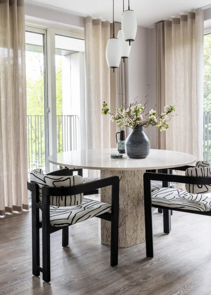 urban contemporary neutral apartment dining table geometric black and white chairs with travertine stone octagonal table