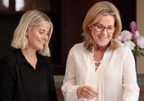 Two people looking over designs