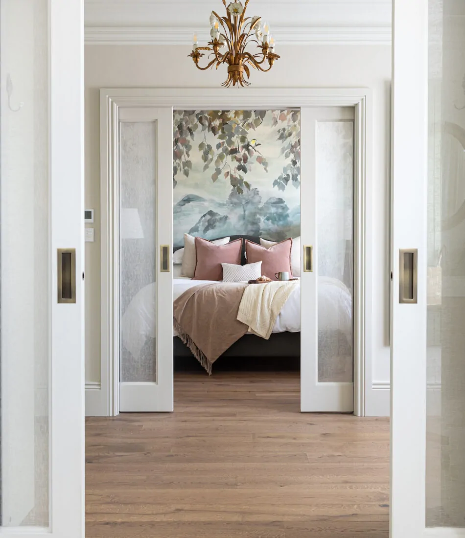 Contemporary Bedroom Designed with Bespoke headboard and Mural Wallpaper by Pfeiffer Design. Neutral colour palette with warm lighting design