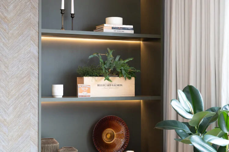 Contemporary Snug Shelving Designed with Bespoke Joinery by Pfeiffer Design. Warm wood joinery with dark green paint in recess and textured wallpaper with warm LED lighting design