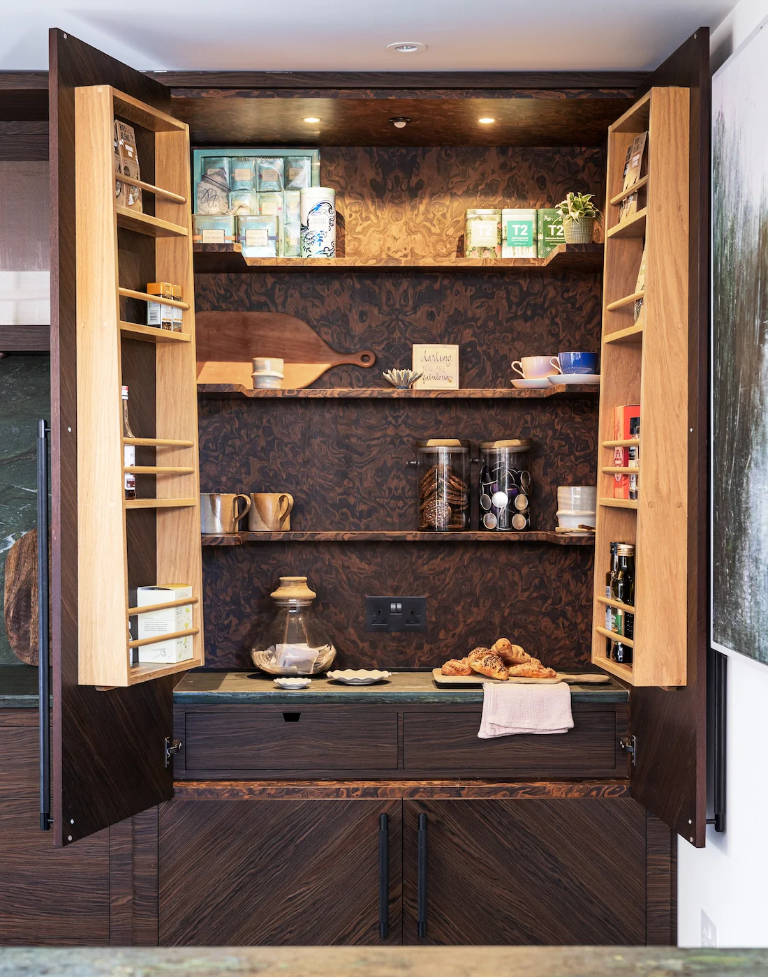 Dark wood pantry cupboard with integrated joinery / shelving
