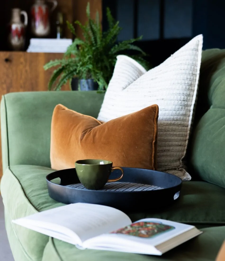 mid century modern beach house in East Sussex bespoke upholstered sofa in soft green velvet with bespoke scatter cushion scheme