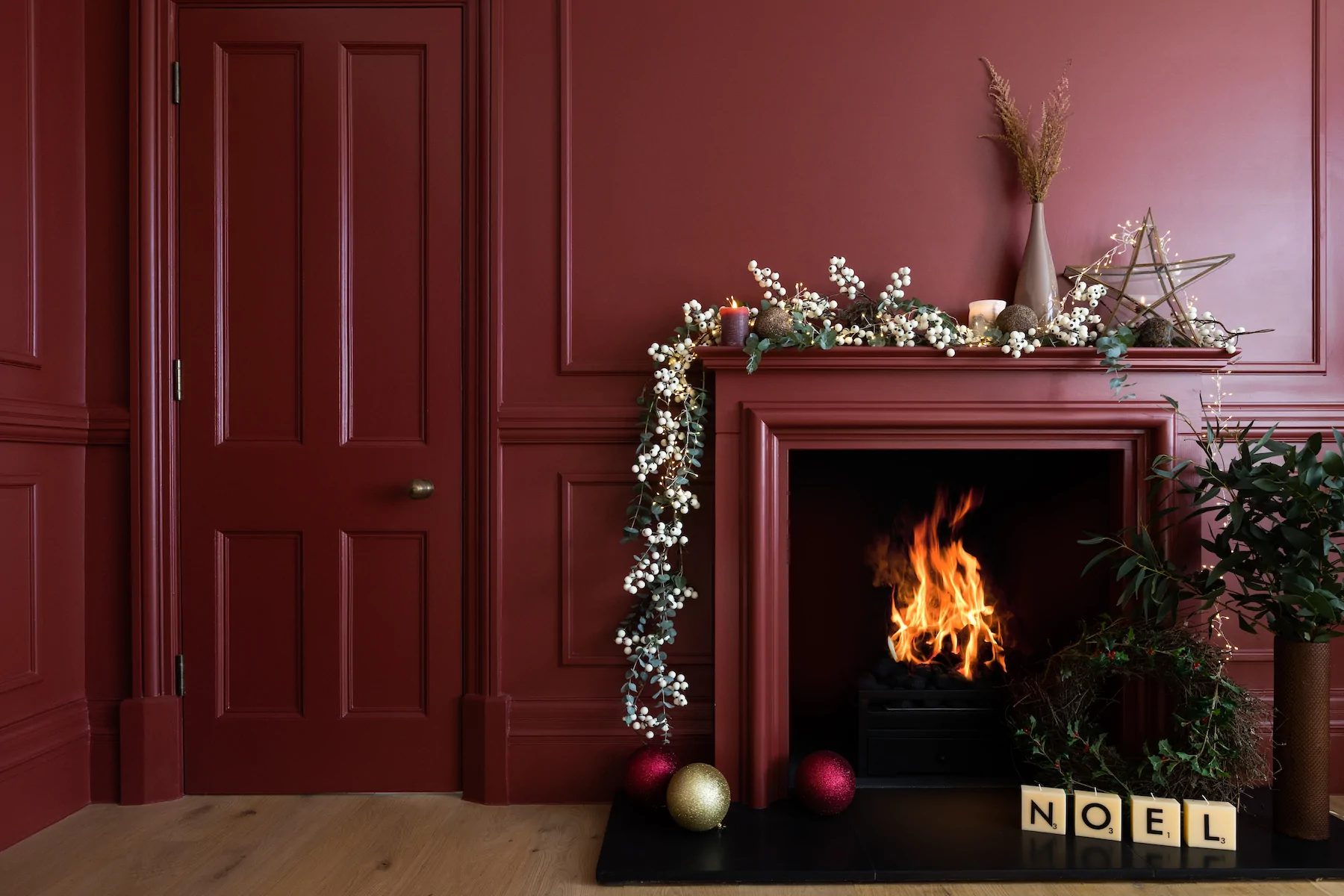 Deep Red Room with Fireplace and Christmas Decorations
