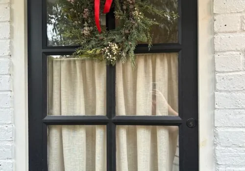 Festive wreath hanging on a brown door