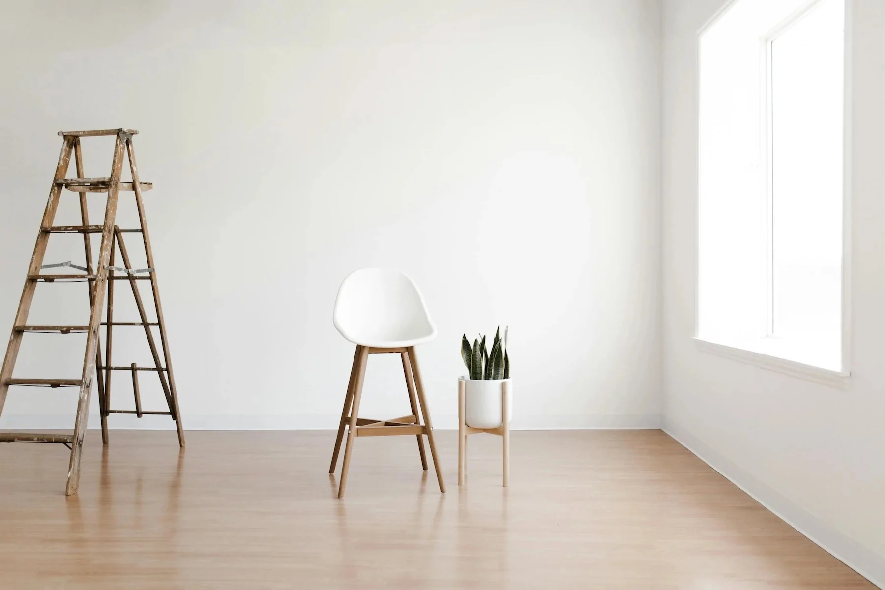 basic interior white walls with ladder and white chair