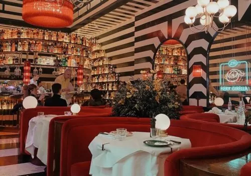 black and white striped walls, ceiling and floor with red seating