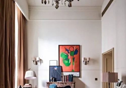 Bedroom design high ceilings and neutral tones with pops of colour in artwork