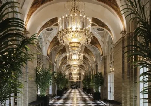 Hotel design with large architectural ceilings and checkerboard black and white floor tiles