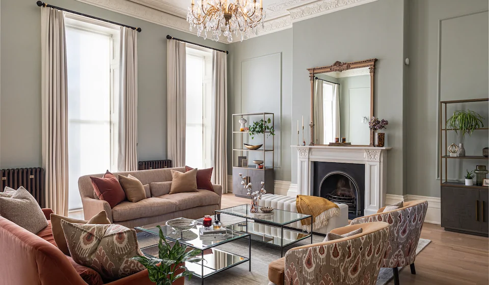 Regency Townhouse Lounge Living Room Interior Design with pops of red, yellow, blue, green warm tones and tall ceilings