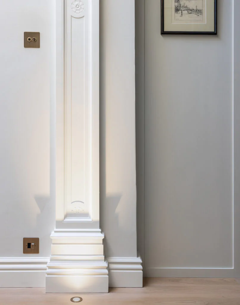 Architectural features within home being lit by floor spot lights - lighting design package