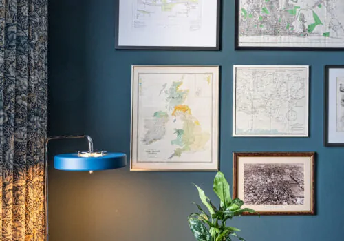 Study, Desk, Library space with navy walls and blue, orange pops of colour, patterned curtains and framed collage of maps