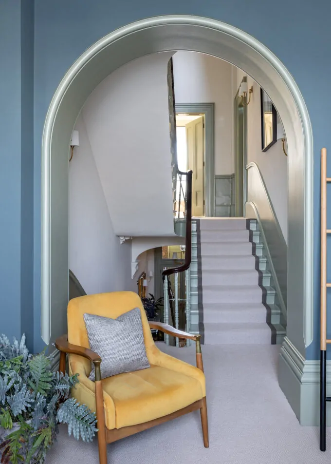 View of landing through archway, contrast paint on walls to skirting, green, blues, yellows