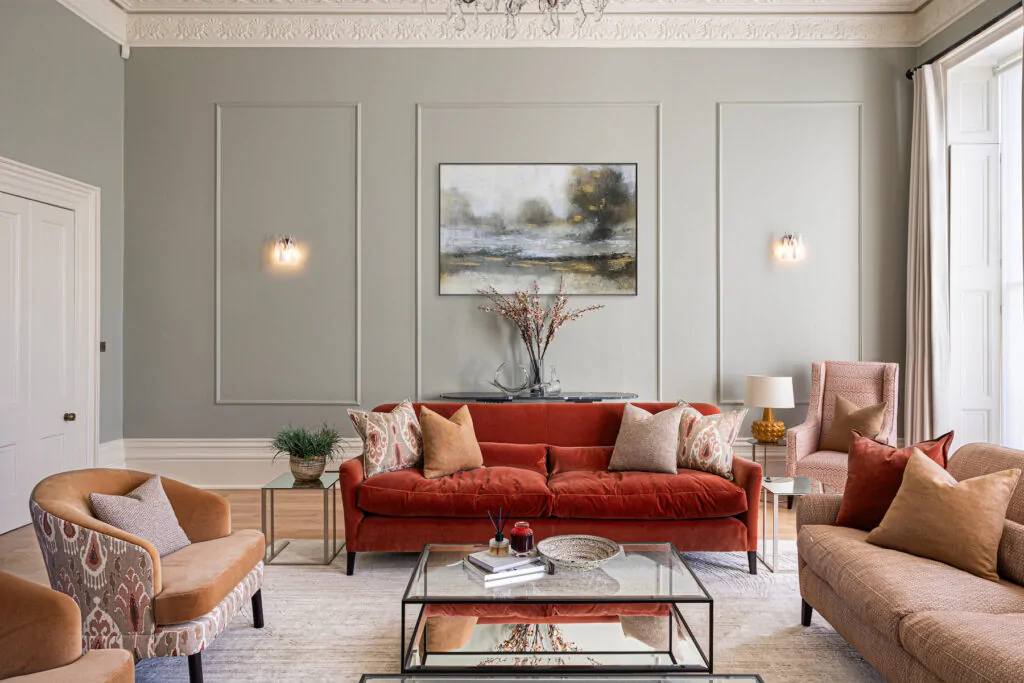 Regency Townhouse Lounge Living Room Interior Design with red, beige, warm patterns and yellow cushions
