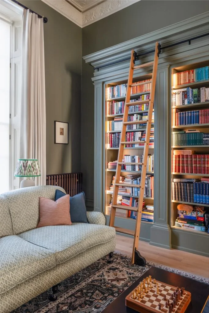 Regency Townhouse Lounge Living Room Interior Design with pops of red, yellow, blue, green warm tones and tall ceilings