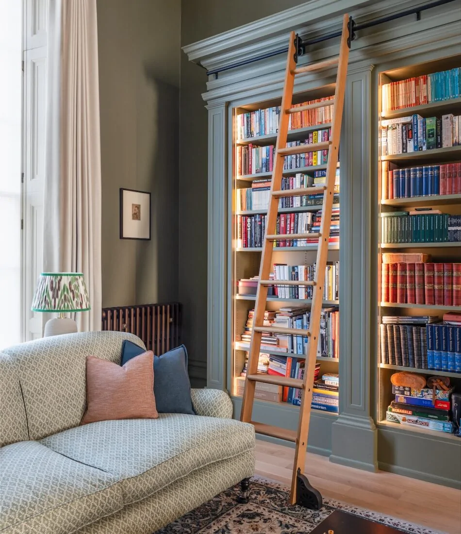 Regency Townhouse Lounge Living Room Interior Design with pops of red, yellow, blue, green warm tones and tall ceilings