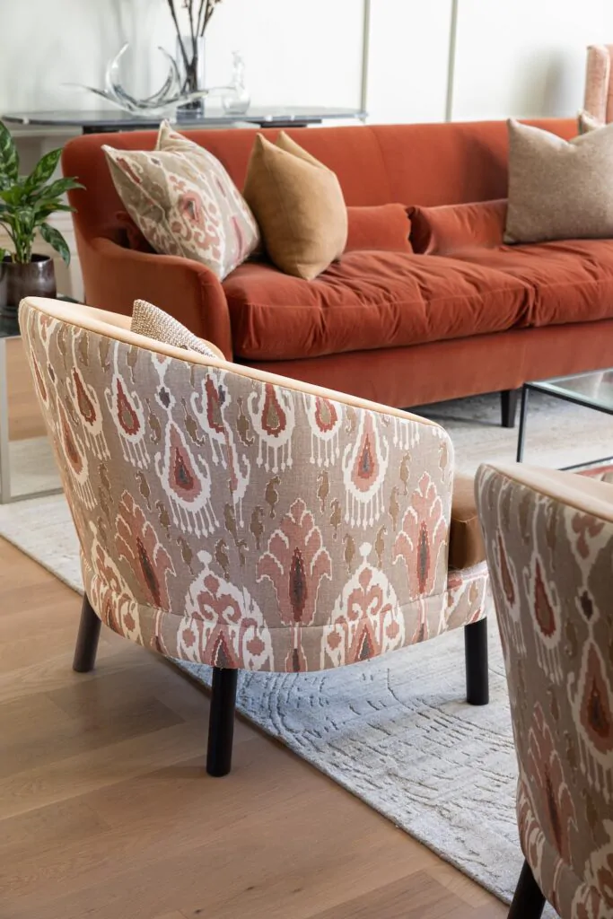 Colourful living room interior design with bespoke made armchairs with decorative backing